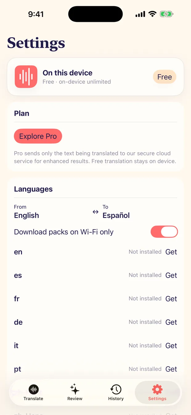 The Settings screen on iPhone showing an On this device plan card, an Explore Pro button with a note that Pro sends only the text being translated, the From and To language pair, a Download packs on Wi-Fi only toggle and a list of installable language packs.