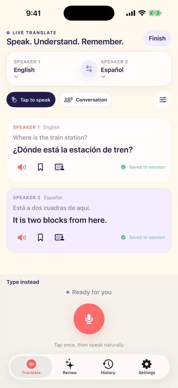 The Live Translate screen on iPhone: a Speaker 1 English turn reading Where is the train station? rendered as ¿Dónde está la estación de tren?, and a Speaker 2 Español reply rendered back into English, each marked Saved to session, above a Tap to speak microphone control and a Type instead fallback.
